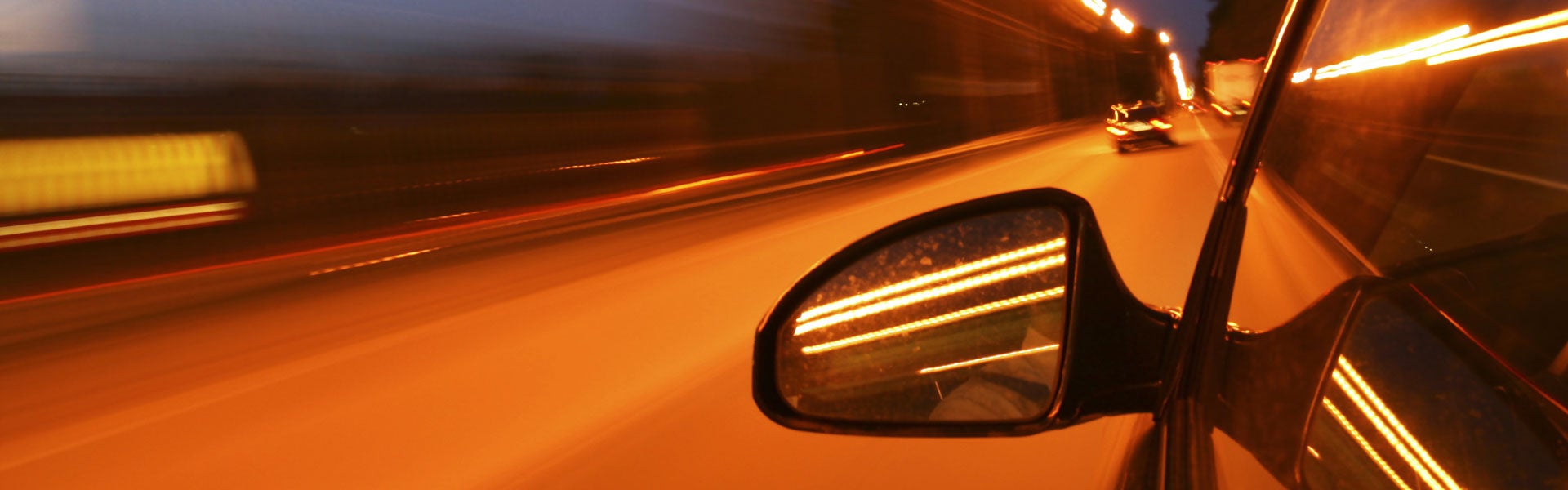 Car driving fast at night with motion blur lights